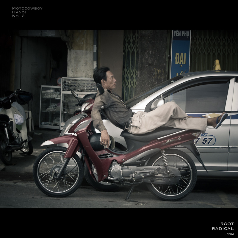 motocowboy-hanoi-no2 Man sleeping on his motorbike.